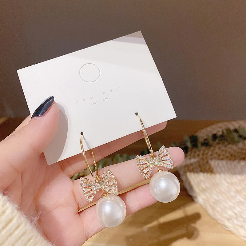 Anting Gadis Manis Mode Temperamen Baru Super Peri Kristal Busur Mutiara Liar Bersih Merah Anting Wanita Grosir Pendientes