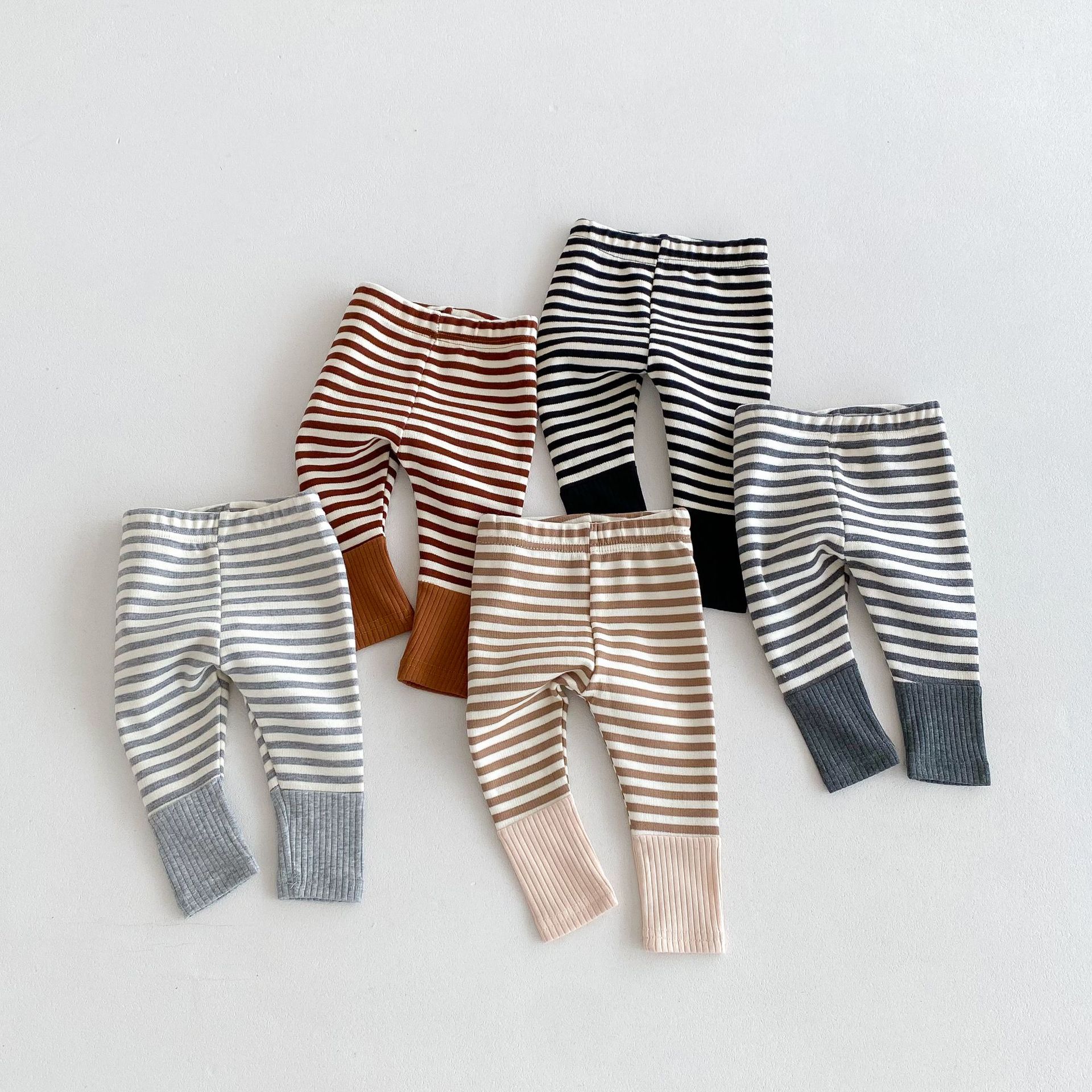 Jesień noworodek Baby Boy dziewczyny cukierkowe kolorowe legginsy Splice spodnie w paski moda odzież dla dzieci