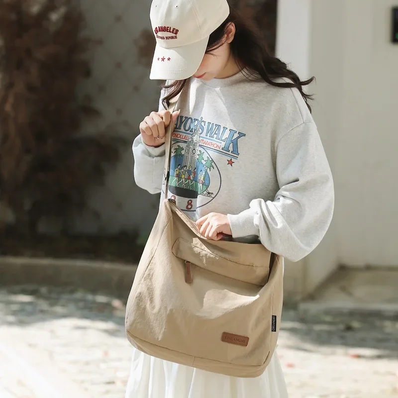 日本人女性男性ショルダークロスボディバッグ大型キャンバスメッセンジャーバッグ学生 2024 ブランドブックバッグ女性のハンドバッグかばん