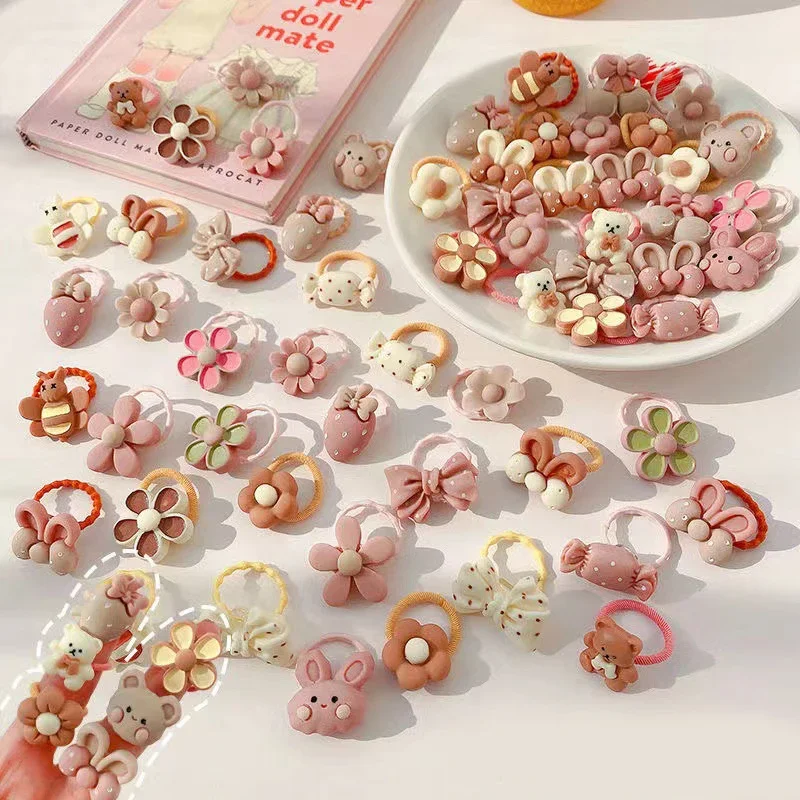 Cinta de goma elástica para el pelo para niña, accesorios para el cabello con dibujos de oso, conejo, lazo de flores, adornos, lote de 50 piezas