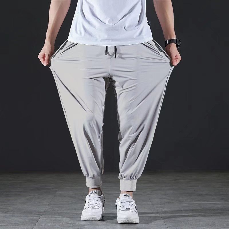 Pantalones informales de seda helada de secado rápido para hombre, pantalón elástico ultrafino de nueve puntos, holgado, con pies de haz sólido, 7XL, verano
