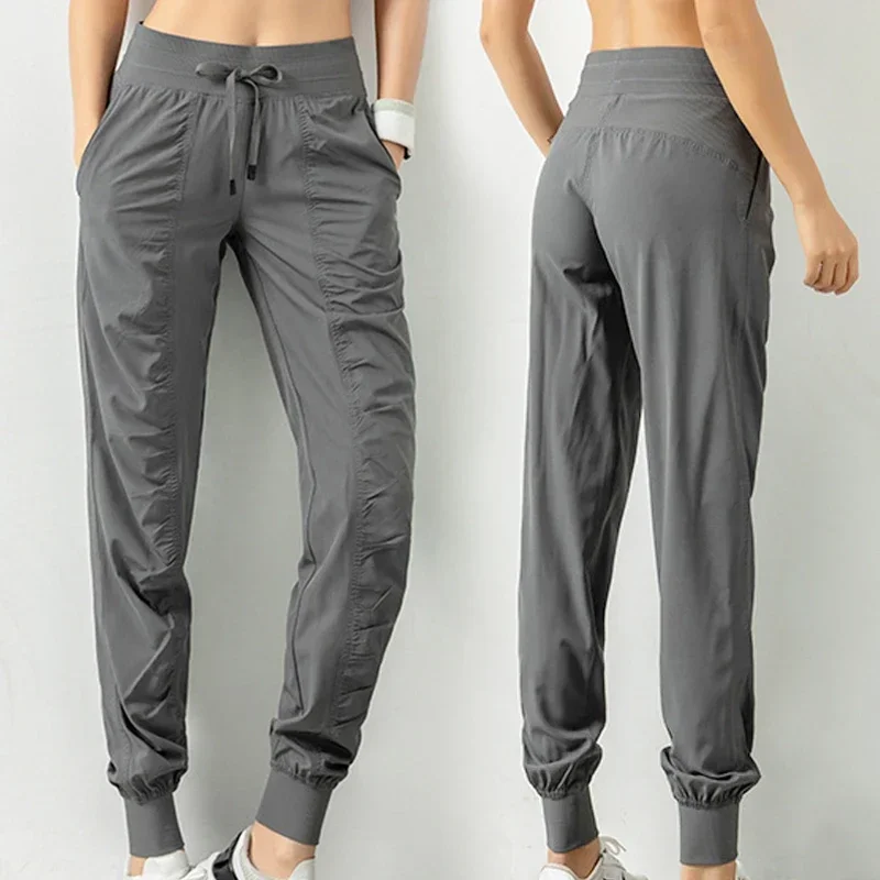 กางเกงวอร์มผ้า Drawstring วิ่งกีฬา Joggers ผู้หญิงด่วนแห้งแข็งแรงยิมฟิตเนสพร้อมกระเป๋าด้านข้างสองกางเกงออกกําลังกาย