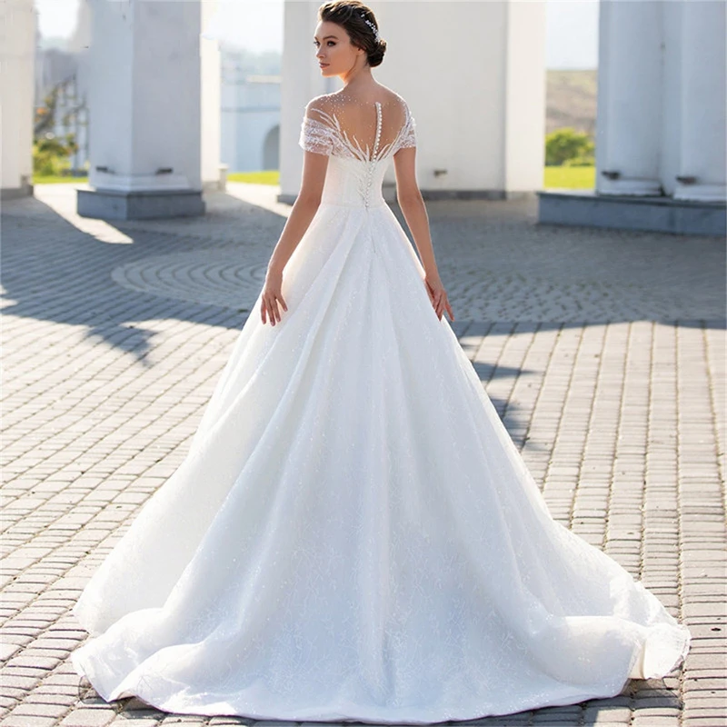 Abiti da sposa trasparenti con scollo a O per la sposa Elegante glitter Perals Pizzo A-Line Abito da sposa Illusion Pieghe Robe De Mariée