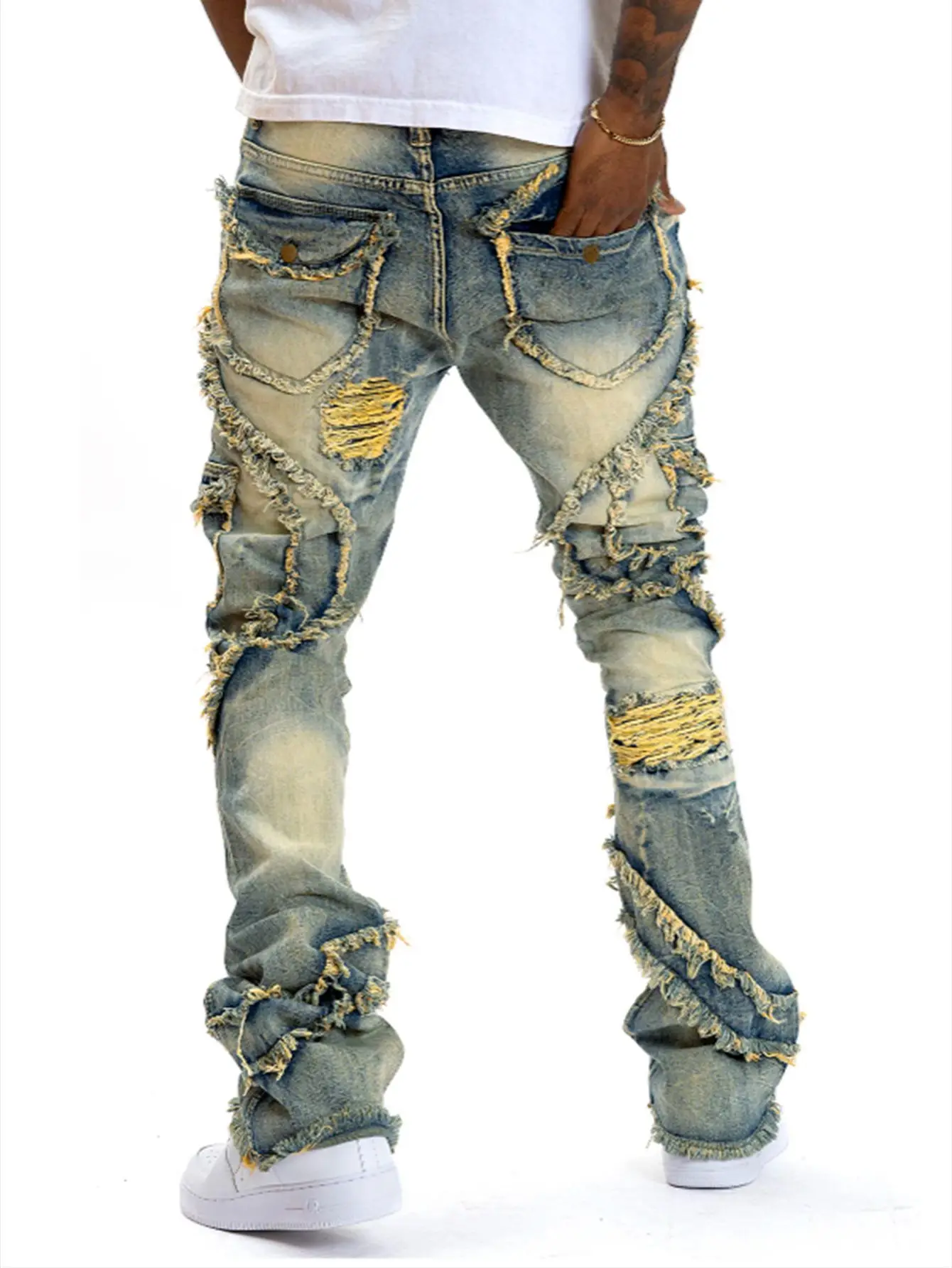 2025 Nuevos pantalones vaqueros casuales para hombres europeos y americanos, moda punk callejero, retro, agujero rasgado, pantalones vaqueros elásticos con borlas ligeramente acampanadas