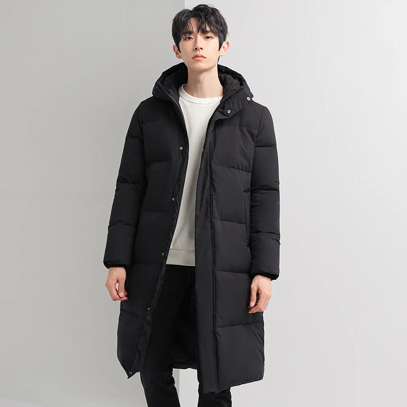 Winter neue Herrenmode vielseitige lange Knie Daunen jacke Mantel Jugend Trend lose lässige Kapuze verdickt warmen wind dichten Mantel männlich