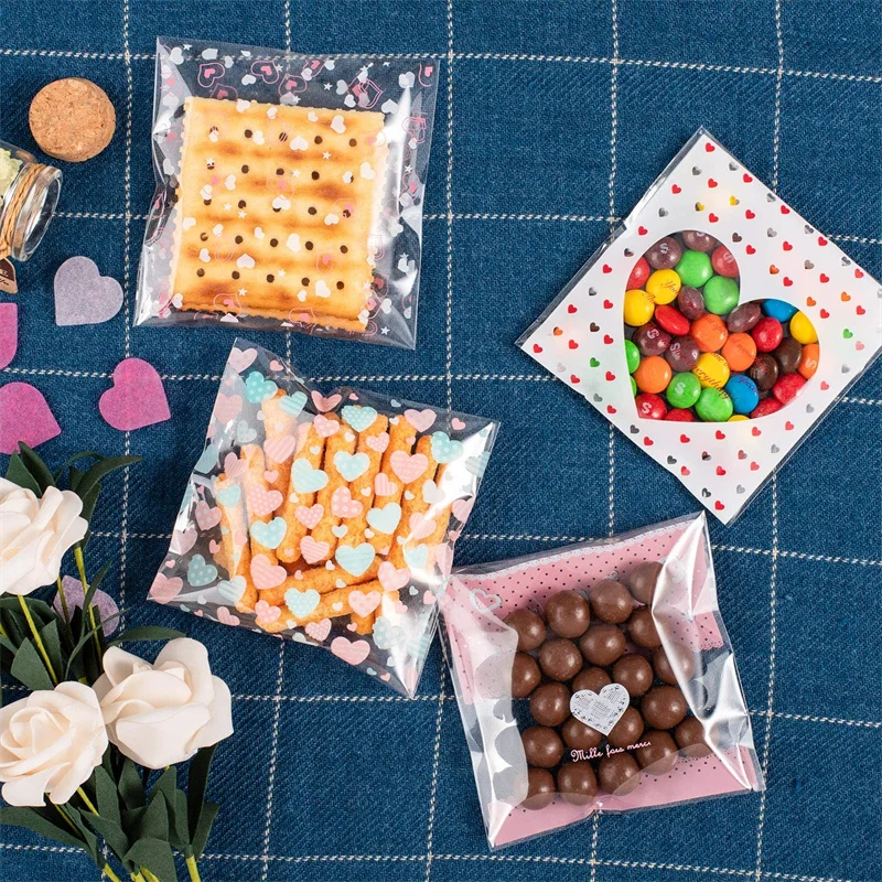100pcs 7x7/10x10 ซม.หัวใจพลาสติก CELLO กระเป๋าปิดผนึกด้วยตนเองสําหรับ DIY คุกกี้ขนมขบเคี้ยวแพคเกจตกแต่งขนาดเล็กธุรกิจ