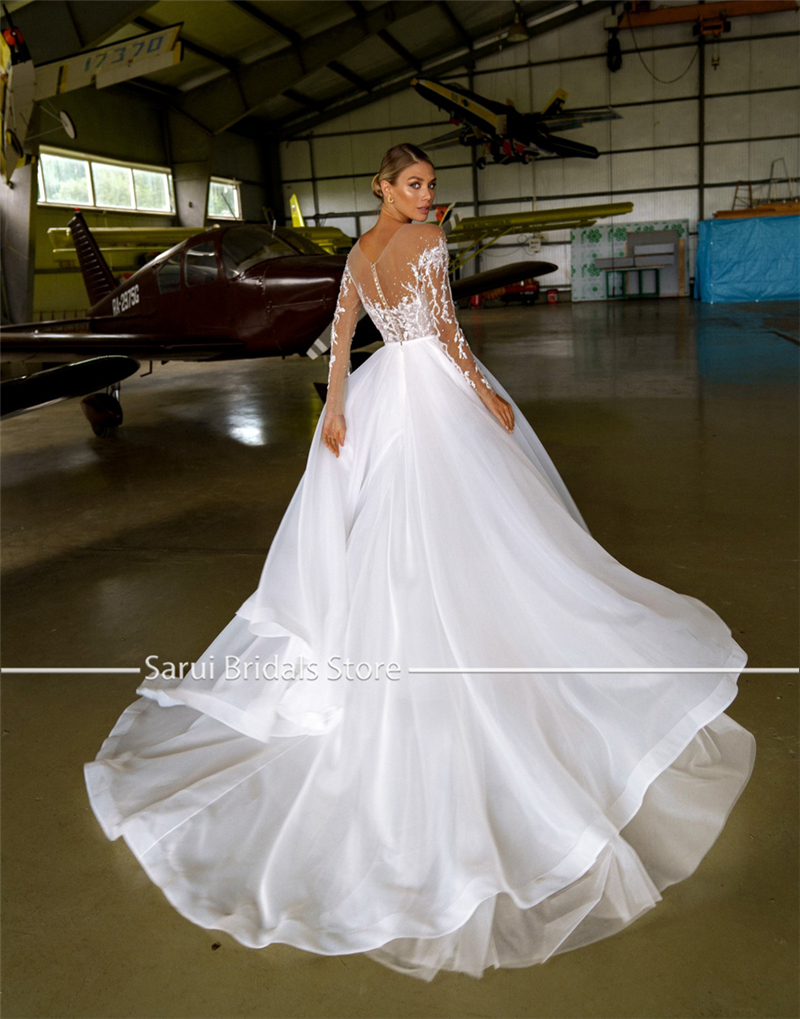 Maßgeschneidertes, transparentes Ausschnittkleid mit schweren Kristallen, langen Ärmeln, weißes Hochzeitskleid aus Organza und Tüll, A-Linie, glitzerndes Brautkleid