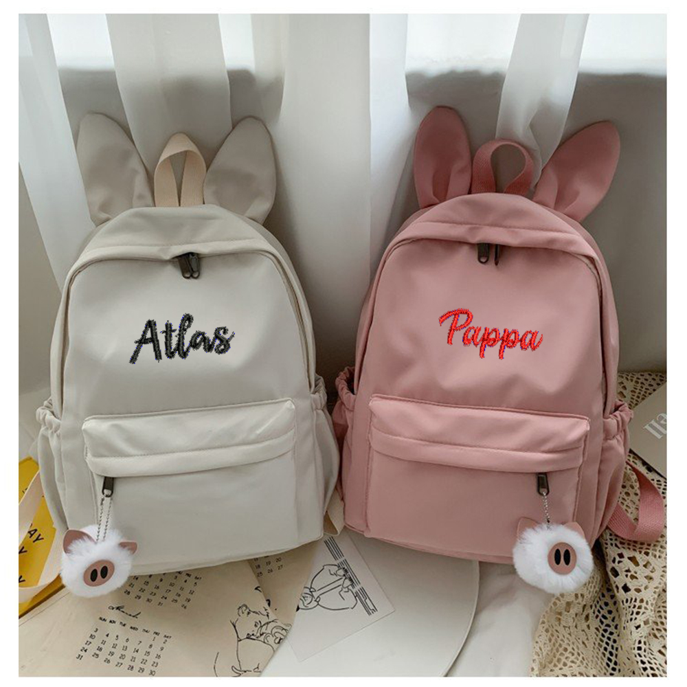 Mochila personalizada y sencilla con Orejas de conejo, nueva moda, tela de nailon, nombre bordado personalizado, bolso de estudiante para hombres y mujeres