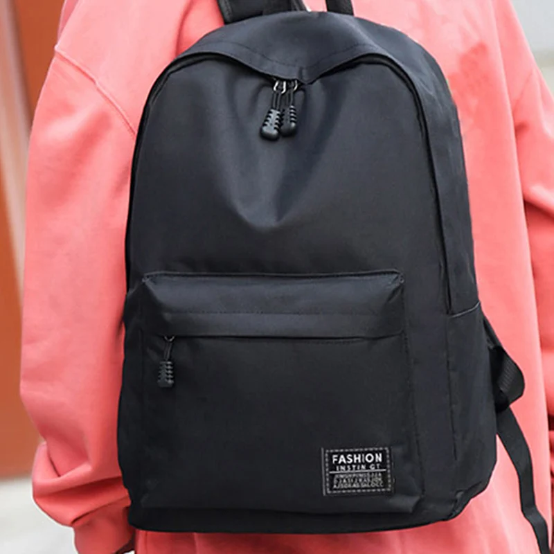 Zaino in stile neutro per ragazzi e ragazze, adatto per viaggi d'affari. Materiale in puro nylon nero, borsa a doppia spalla.