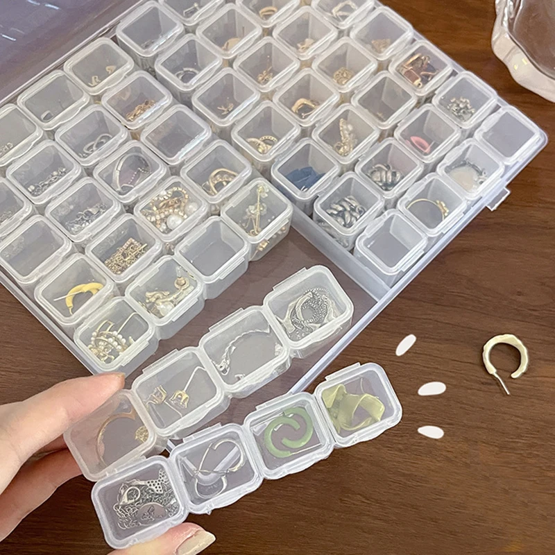 Nuovo 28 griglie scatola di immagazzinaggio di gioielli in plastica collana orecchini anelli imballaggio di gioielli organizzatore scatola di immagazzinaggio di pillole portatile