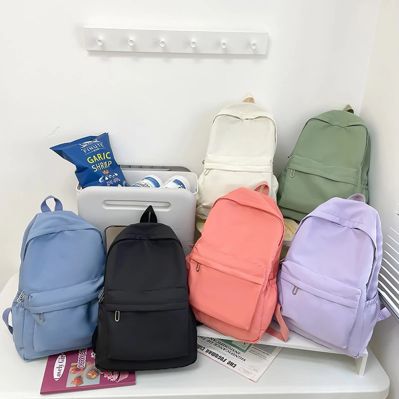 กระเป๋าเป้สะพายหลังลำลองสีทึบเรียบง่ายน้ำหนักเบาและกระเป๋านักเรียนมัธยมปลายกระเป๋าเป้สะพายหลังอเนกประสงค์เหมาะสำหรับการเดินทาง, โรงเรียน