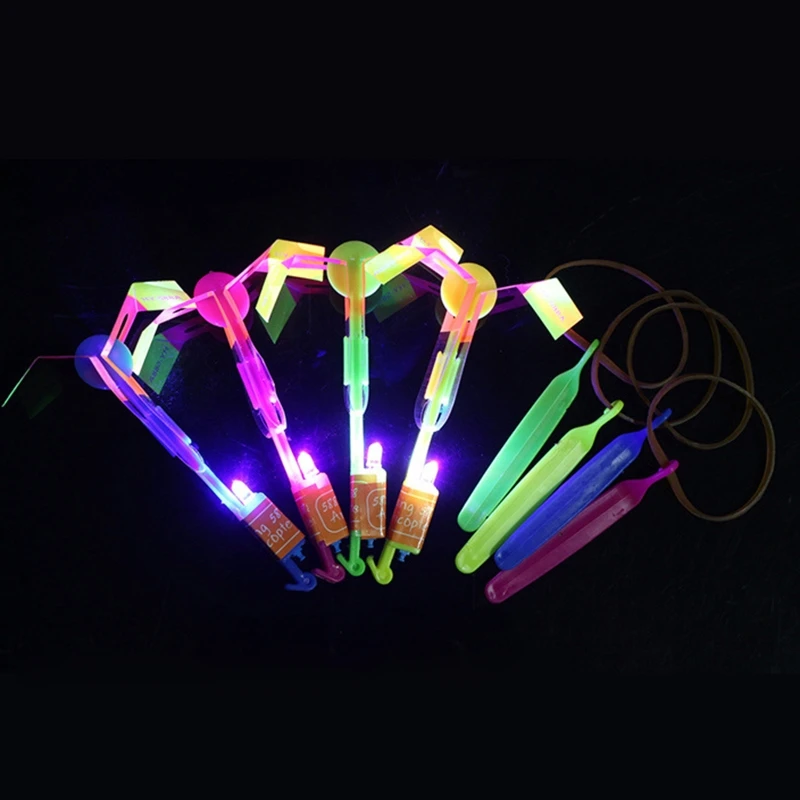 Divertido deporte al aire libre luz LED flecha cohete helicóptero tirachinas avión juguetes voladores banda de goma catapulta libélula de bambú regalo