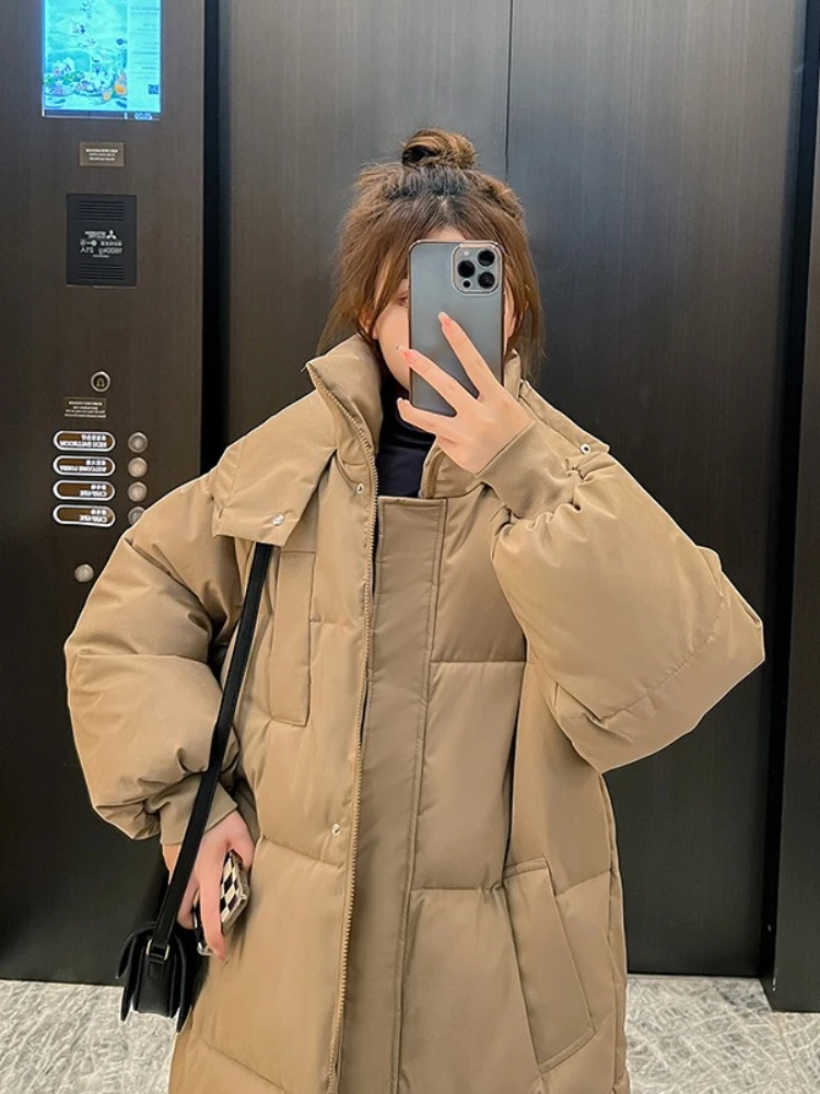 Longo engrossado para baixo algodão pão estilo casaco feminino inverno 2025 outerwear coreano solto longo na altura do joelho sólido jaqueta com capuz