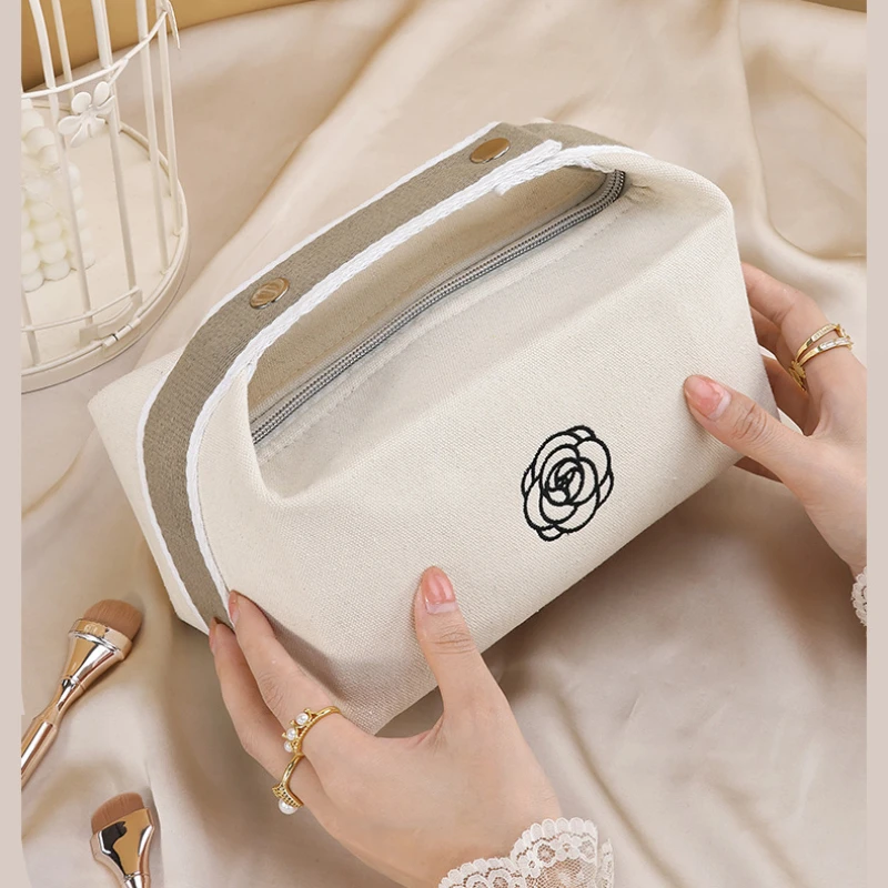 Bolsa de maquiagem portátil de lona de camélia premium para viagens, produtos de higiene pessoal de grande capacidade, cosméticos, bolsa de armazenamento de cuidados com a pele