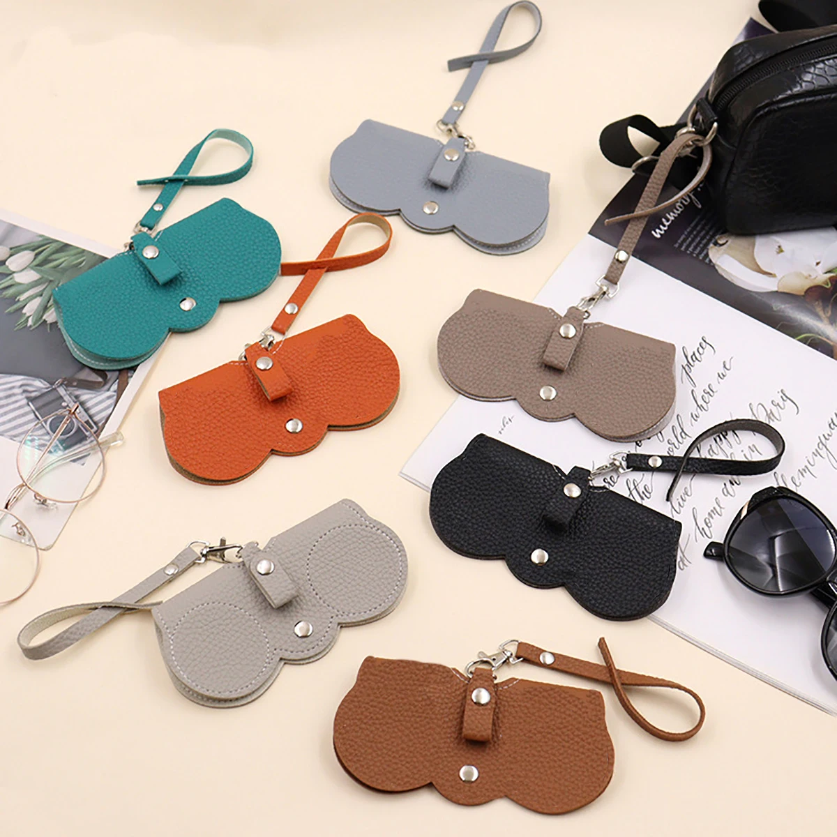 Funda para gafas con relieve de Litchi, bonitas gafas de sol colgantes de cuero PU, bolsa de almacenamiento para gafas de lectura, soporte portátil para gafas de viaje, 1 ud.