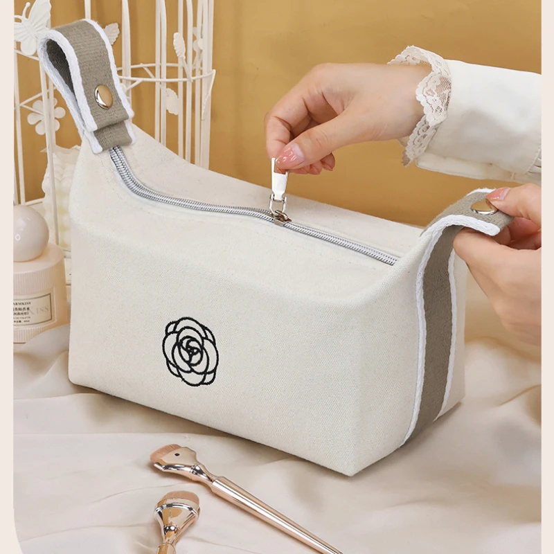 Bolsa de maquiagem portátil de lona de camélia premium para viagens, produtos de higiene pessoal de grande capacidade, cosméticos, bolsa de armazenamento de cuidados com a pele