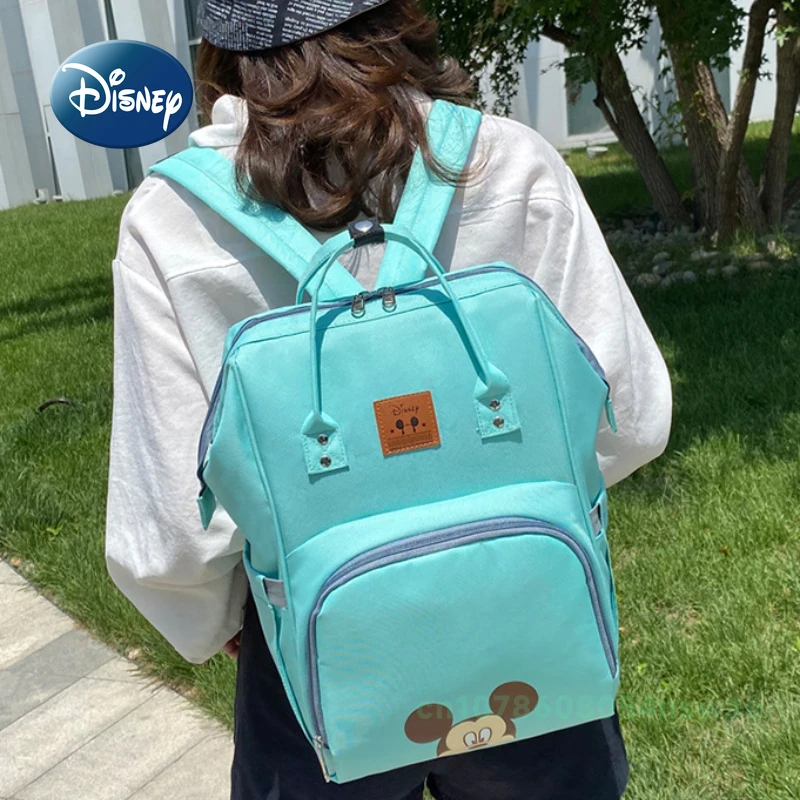 Disney's New กระเป๋าผ้าอ้อมกระเป๋าเป้สะพายหลังแบรนด์หรูกระเป๋าแฟชั่นเด็กการ์ตูนน่ารักกระเป๋าผ้าอ้อมเด็กขนาดใหญ่ความจุ Multi Function