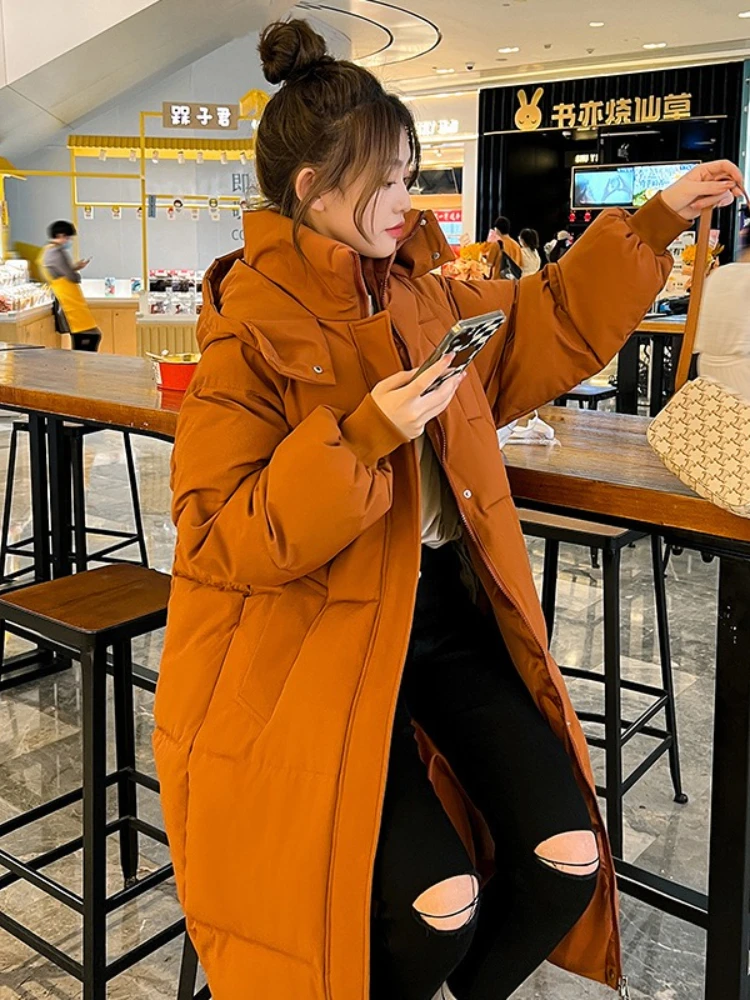 Longo engrossado para baixo algodão pão estilo casaco feminino inverno 2025 outerwear coreano solto longo na altura do joelho sólido jaqueta com capuz