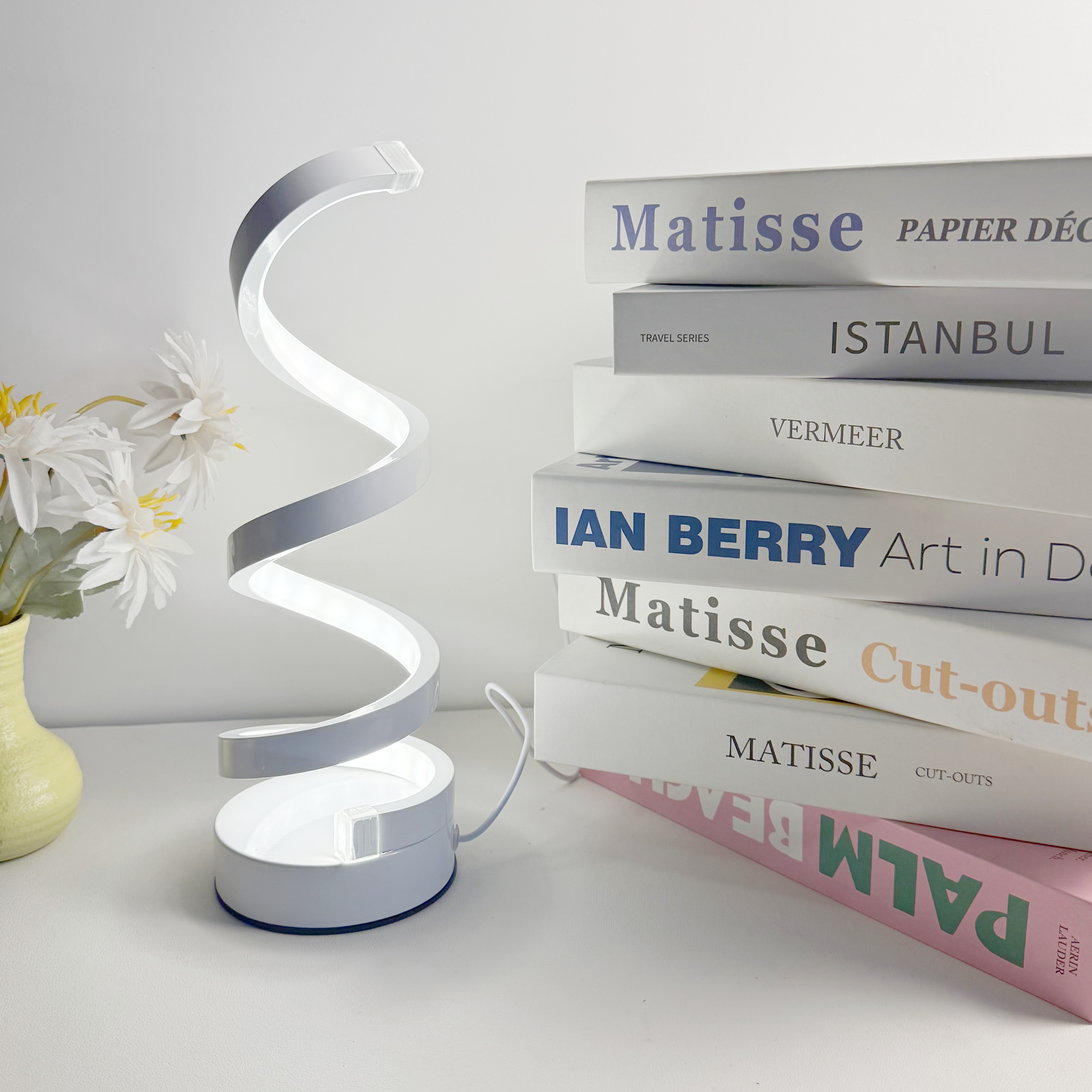 A modern, elegant white spiral desktop lamp, powered by USB with three-color dimming, suitable for various types of rooms.