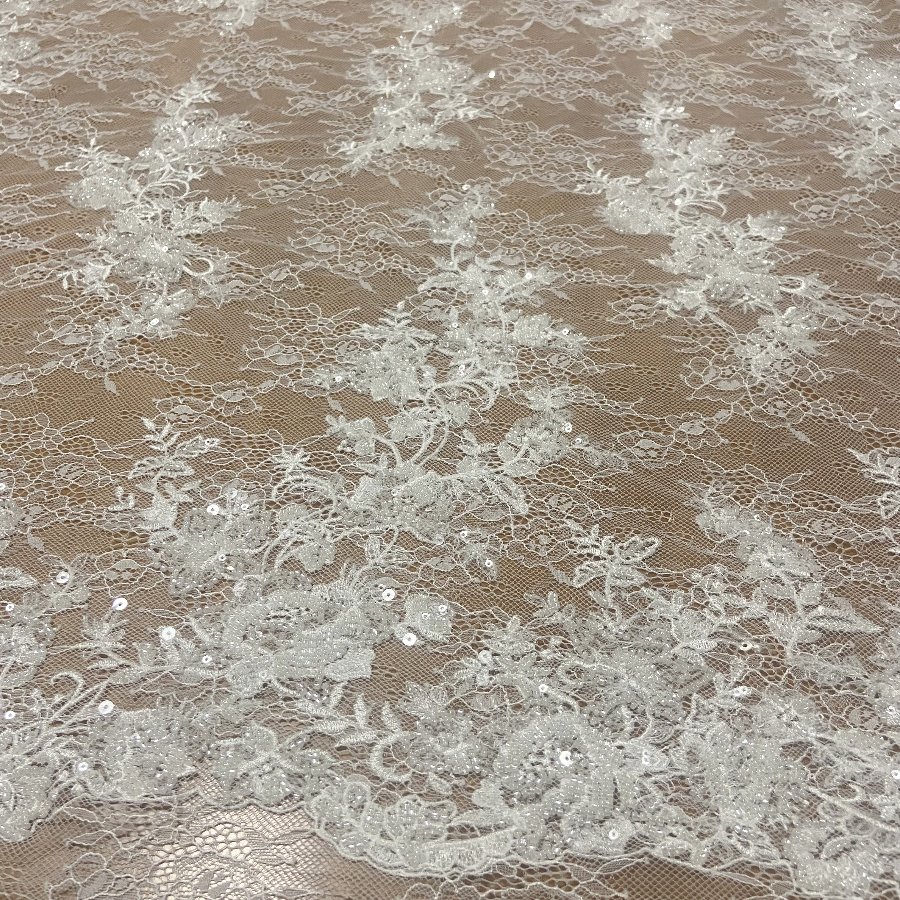 Las nuevas flores aberturas en la tela de encaje del vestido de cuentas de uñas