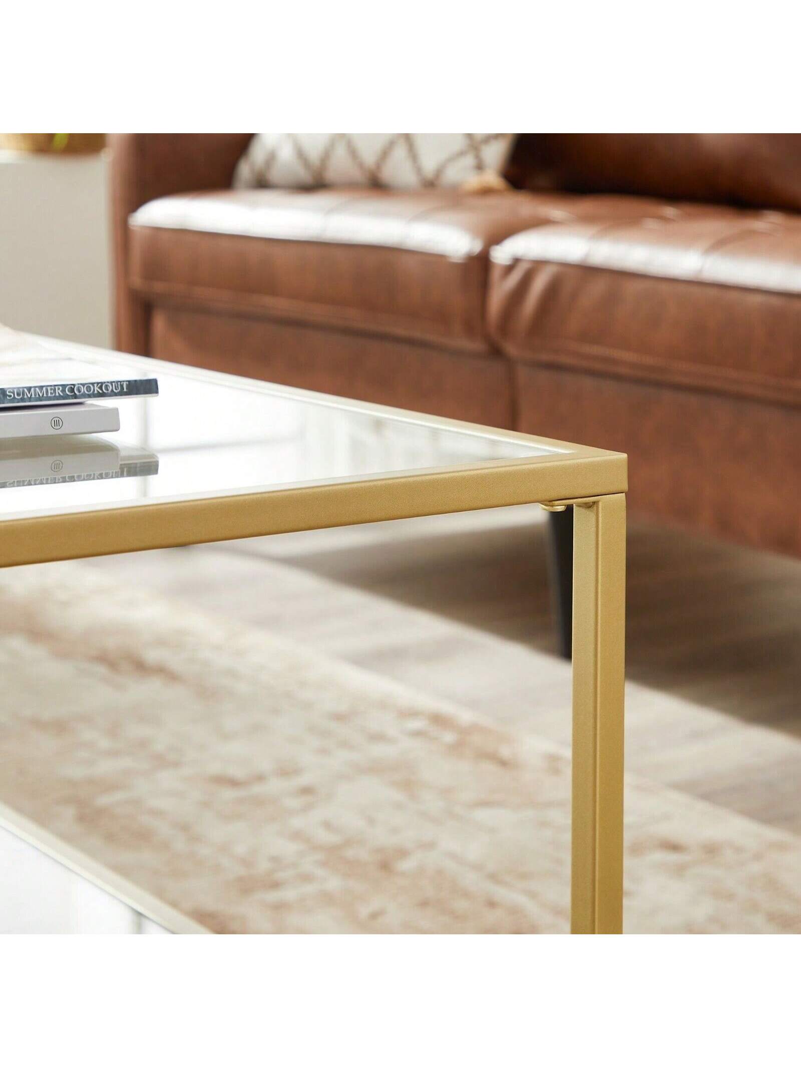 Mesa de centro de vidrio VASAGLE con almacenamiento Superficie de vidrio templado, marco de acero 100x55x45 cm, Color dorado
