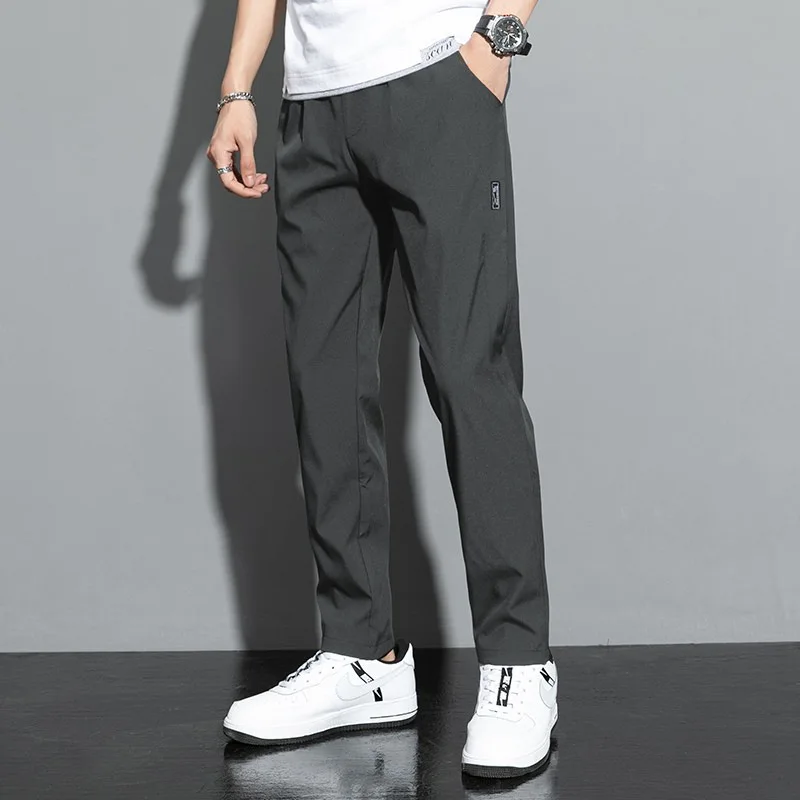Pantaloni da uomo 2025 estate nuovi pantaloni casual da lavoro sottili neri grigi pantaloni sportivi a gamba dritta elastici e traspiranti per esterni