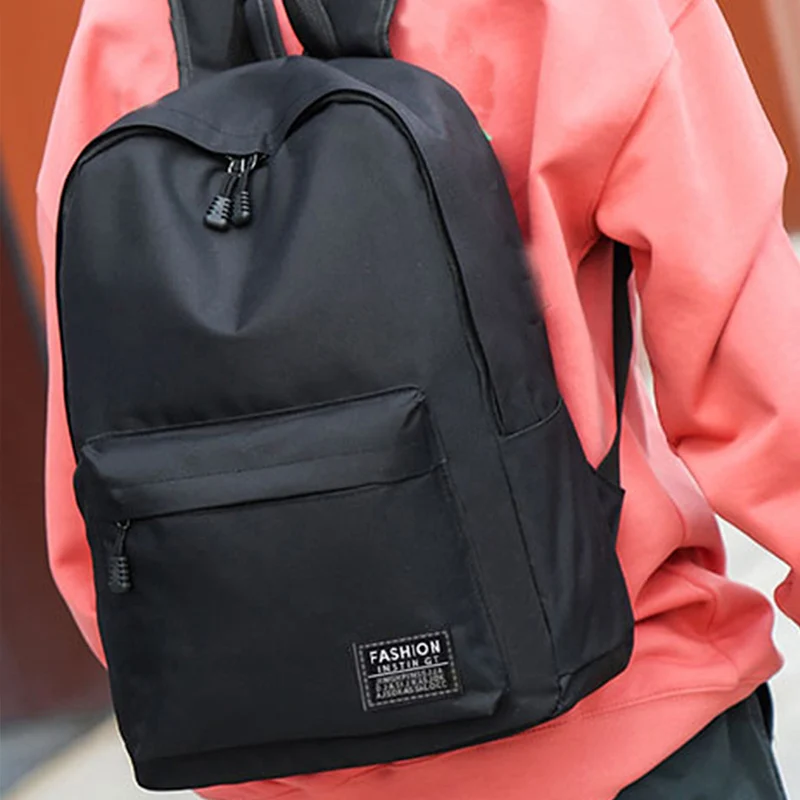 Zaino in stile neutro per ragazzi e ragazze, adatto per viaggi d'affari. Materiale in puro nylon nero, borsa a doppia spalla.