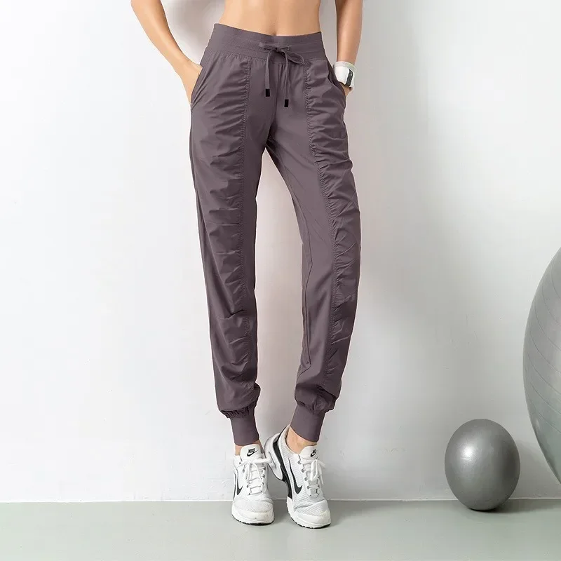 กางเกงวอร์มผ้า Drawstring วิ่งกีฬา Joggers ผู้หญิงด่วนแห้งแข็งแรงยิมฟิตเนสพร้อมกระเป๋าด้านข้างสองกางเกงออกกําลังกาย