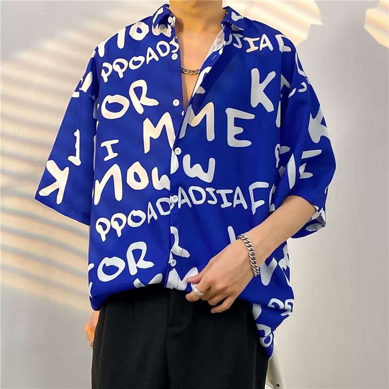 Camicia quotidiana estiva da uomo alla moda di strada Camicie larghe casual con stampa di cartoni animati hawaiani Top larghi da spiaggia a maniche corte