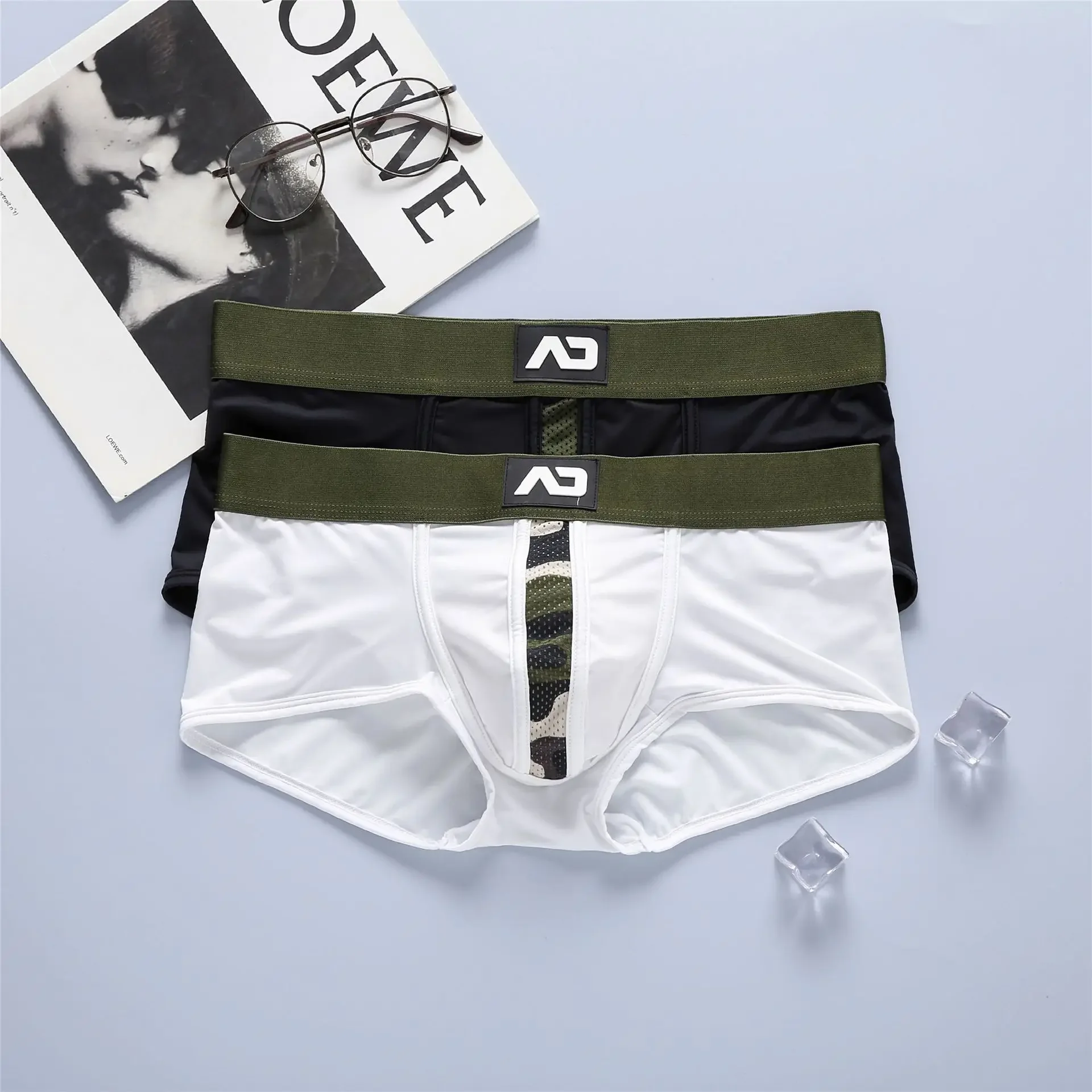 Nuevas bragas boxer para hombre, bolsas tridimensionales elásticas de tiro bajo trituradas con leche, boxers cómodos