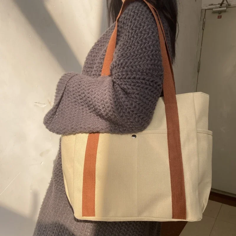 Borsa a tracolla di tendenza di Design di nicchia borsa a tracolla da donna minimalista Versatile alla moda borsa di tela portatile di grande capacità Unisex